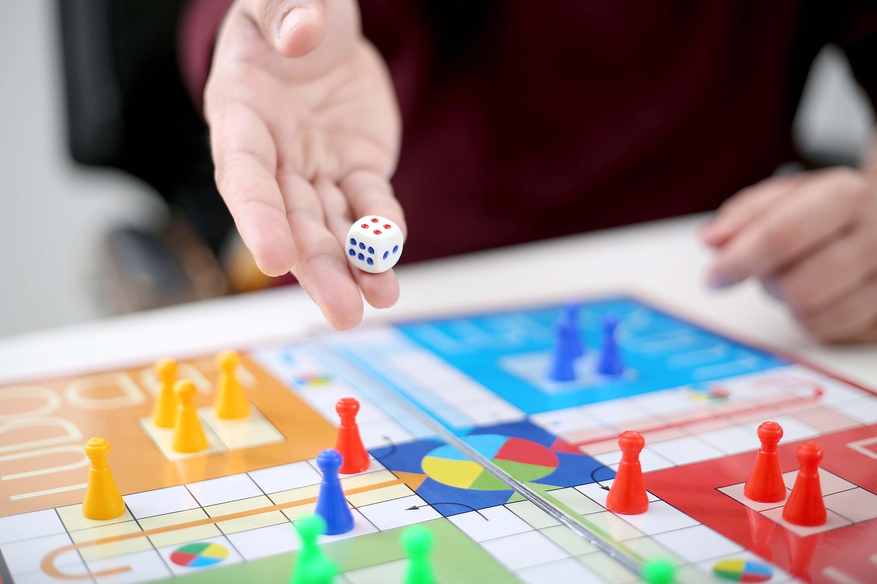 A board game laid out on a table with dice and pieces