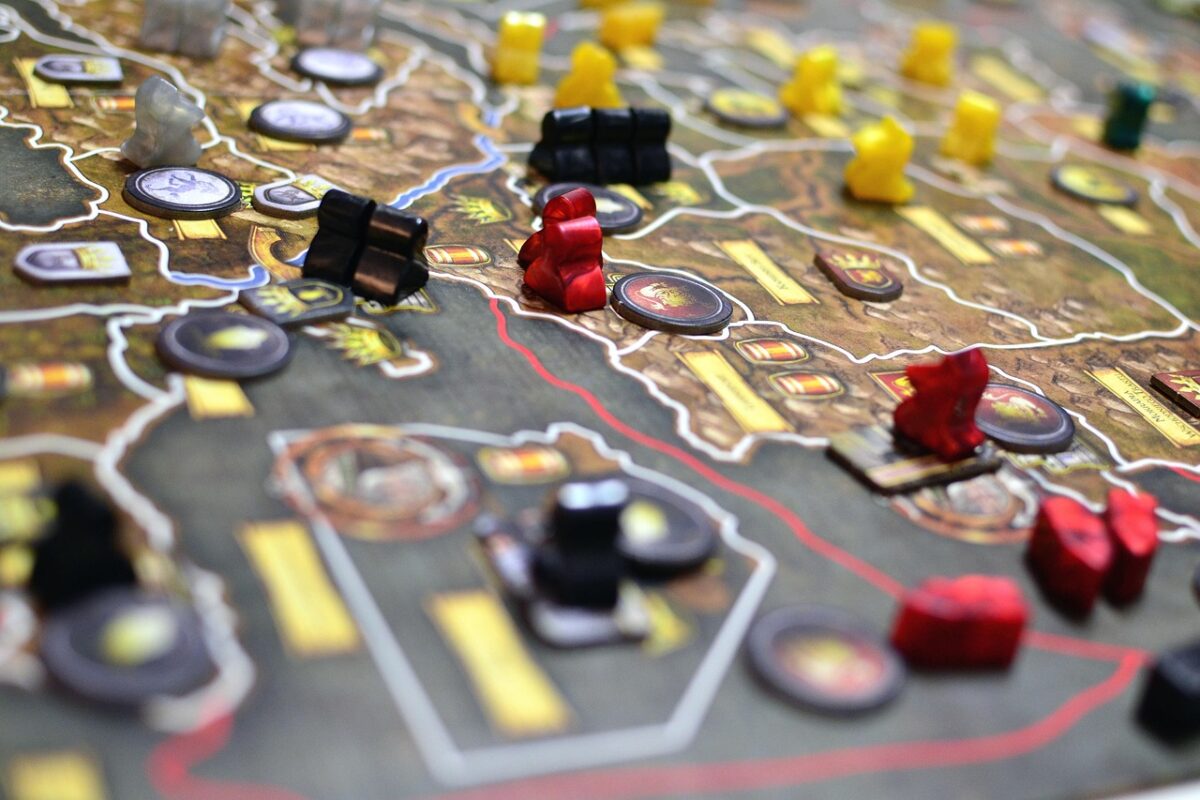 Four people around a table playing a board game