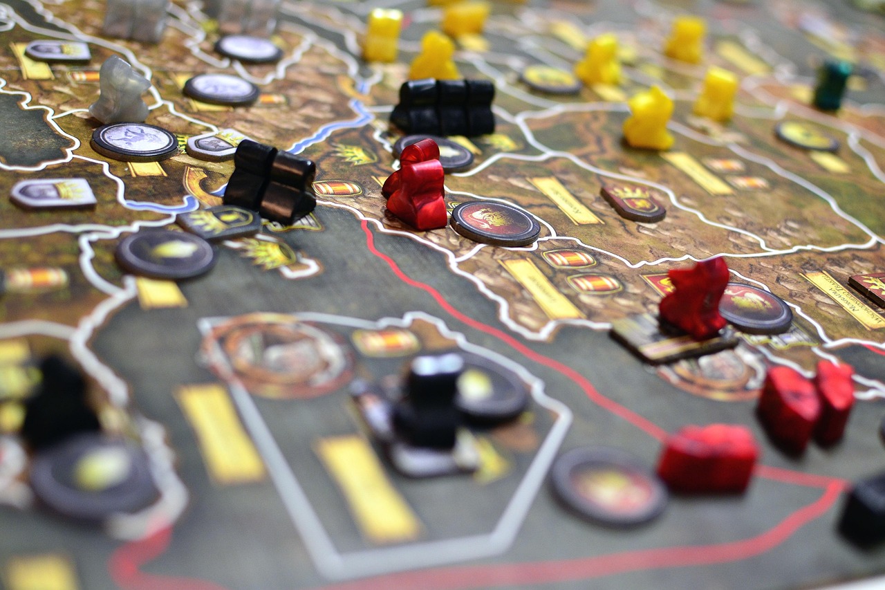 Four people around a table playing a board game